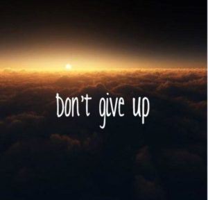 A sunset over clouds with the words dont give up
