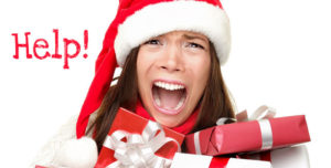 A picture of a woman with her mouth wide open like a scream wearing a santa hat surrounded by wrapped presents with the word help on the left